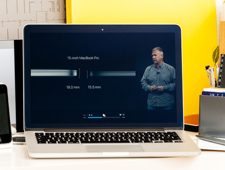 PARIS, FRANCE - OCT 28 2016: Apple Computers website on new MacBook Pro Retina with OLED Touch bar in geek creative room showcasing Apple Keynote presentation of  Philip Schiller talking about the changes of the new laptopのeditorial素材