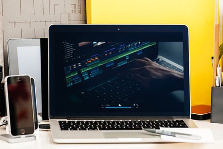 PARIS, FRANCE - OCT 28 2016: Apple Computers website on new MacBook Pro Retina with OLED Touch bar in geek creative room showcasing Apple Keynote presentation of video editing on MAcBook proのeditorial素材
