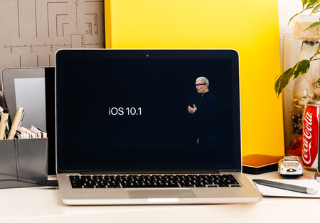 PARIS, FRANCE - OCT 28 2016: Apple Computers website on new MacBook Pro Retina with OLED Touch bar in geek creative room showcasing Apple Keynote presentation of iOS 10.10 securityのeditorial素材