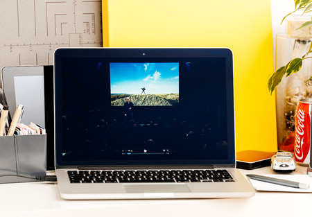 PARIS, FRANCE - OCT 28 2016: Apple Computers website on new MacBook Pro Retina with OLED Touch bar in geek creative room showcasing Apple Keynote presentation of iPhone 7 plus photographs by Tim Cookのeditorial素材