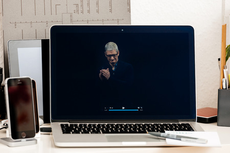 PARIS, FRANCE - OCT 28 2016: Apple Computers website on new MacBook Pro Retina with OLED Touch bar in geek creative room showcasing Apple Keynote Tim Cook thanking for the eventのeditorial素材