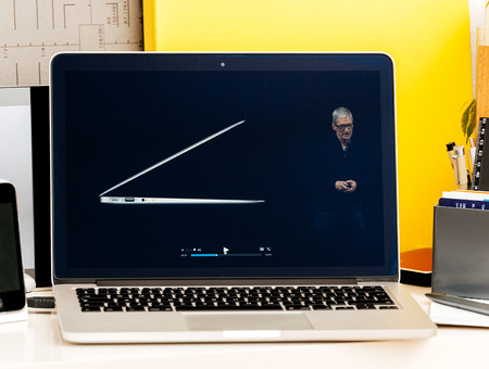 PARIS, FRANCE - OCT 28 2016: Apple Computers website on new MacBook Pro Retina with OLED Touch bar in geek creative room showcasing Apple Keynote Tim Cook talking about the MacBook Pro and its advantagesのeditorial素材