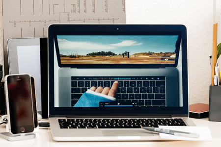 PARIS, FRANCE - OCT 28 2016: Hand touch OLED bar - Apple Computers website on new MacBook Pro Retina with OLED Touch bar in geek creative room showcasingのeditorial素材