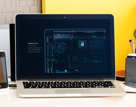 PARIS, FRANCE - OCT 28 2016: Apple Computers website on new MacBook Pro Retina with OLED Touch bar in geek creative room showcasing Apple Keynote presentation of Radeon Pro 4 Gb GPU video cardのeditorial素材