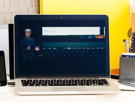PARIS, FRANCE - OCT 28 2016: Apple Computers website on new MacBook Pro Retina with OLED Touch bar in geek creative room showcasing Apple Keynote presentation Craig Federighi talking about new MacBook Proのeditorial素材