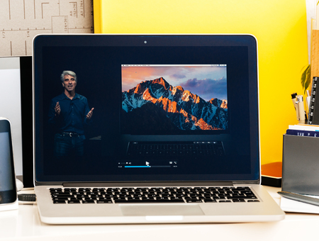 PARIS, FRANCE - OCT 28 2016: Apple Computers website on new MacBook Pro Retina with OLED Touch bar in geek creative room showcasing Apple Keynote presentation Craig Federighi talking about new MacBook Proのeditorial素材