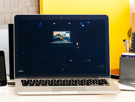 PARIS, FRANCE - OCT 28 2016: Apple Computers website on new MacBook Pro Retina with OLED Touch bar in geek creative room showcasing Apple Keynote presentation of Tim Cook talking about Macbook Proのeditorial素材