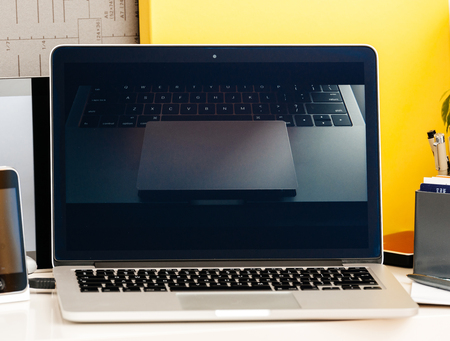 PARIS, FRANCE - OCT 28 2016: Apple Computers website on new MacBook Pro Retina with OLED Touch bar in geek creative room showcasing Apple Keynote presentation of Jhony Ive presenting the new laptop film with trackpad specksのeditorial素材