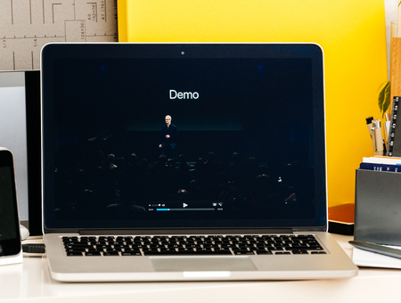 PARIS, FRANCE - OCT 28 2016: Apple Computers website on new MacBook Pro Retina with OLED Touch bar in geek creative room showcasing Apple Keynote - Tim Cook with demo text at keynoteのeditorial素材