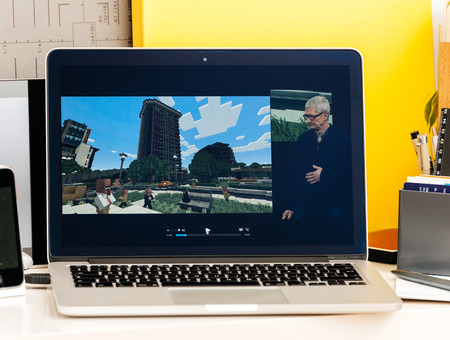 PARIS, FRANCE - OCT 28 2016: Apple Computers website on new MacBook Pro Retina with OLED Touch bar in geek creative room showcasing Apple Keynote - 'Minecraft Pocket Edition' Coming to Apple TVのeditorial素材