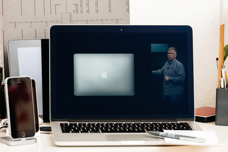 PARIS, FRANCE - OCT 28 2016: Apple Computers website on new MacBook Pro Retina with OLED Touch bar in geek creative room showcasing Apple Keynote, Thilip Schiller talking about old laptopのeditorial素材