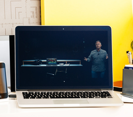 PARIS, FRANCE - OCT 28 2016: Apple Computers website on new MacBook Pro Retina with OLED Touch bar in geek creative room showcasing Apple Keynote presentation of laptop performance, CPU GPU and Thunderbolt 3 portsのeditorial素材