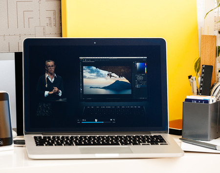 PARIS, FRANCE - OCT 28 2016: Apple Computers website on new MacBook Pro Retina with OLED Touch bar in geek creative room showcasing Apple Keynote presentation of Bradee Evans from Adobe OLED Photoshop inegrationのeditorial素材