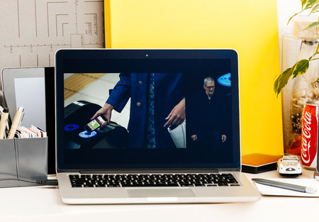 PARIS, FRANCE - OCT 28 2016: Apple Computers website on new MacBook Pro Retina with OLED Touch bar in geek creative room showcasing Apple Keynote presentation of Apple Pay in Japan by Tim Cookのeditorial素材