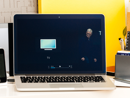 PARIS, FRANCE - OCT 28 2016: Apple Computers website on new MacBook Pro Retina with OLED Touch bar in geek creative room showcasing Apple Keynote presentation of Apple TVのeditorial素材