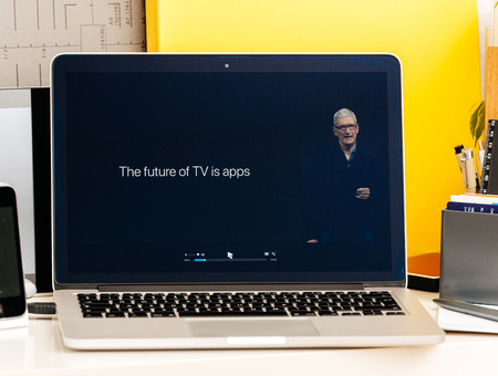 PARIS, FRANCE - OCT 28 2016: Apple Computers website on new MacBook Pro Retina with OLED Touch bar in geek creative room showcasing Apple Keynote , Tim cook talking about the future of Apple TVのeditorial素材