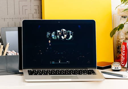 PARIS, FRANCE - OCT 28 2016: Apple Computers website on new MacBook Pro Retina with OLED Touch bar in geek creative room showcasing Apple Keynote talking about the succes of Apple Watchのeditorial素材
