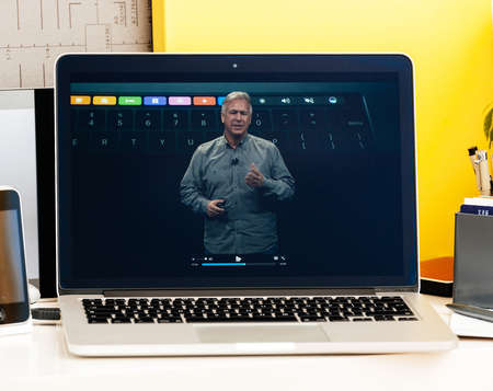 PARIS, FRANCE - OCT 28 2016: Apple Computers website on new MacBook Pro Retina with OLED Touch bar in geek creative room showcasing Apple Keynote presentation of philip Schiller talking about oled bar integrationのeditorial素材