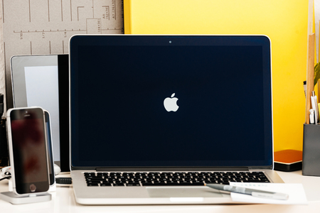 PARIS, FRANCE - OCT 28 2016: Apple Computers website on new MacBook Pro Retina with OLED Touch bar in geek creative room showcasing Apple Keynote - logotype Apple computers on screenのeditorial素材