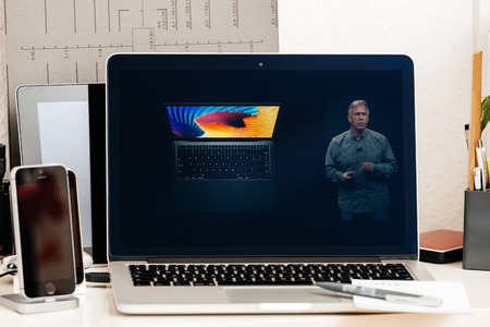 PARIS, FRANCE - OCT 28 2016: Apple Computers website on new MacBook Pro Retina with OLED Touch bar in geek creative room showcasing Apple Keynote presentation of MacBook air replacementのeditorial素材