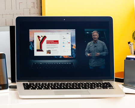 PARIS, FRANCE - OCT 28 2016: Apple Computers website on new MacBook Pro Retina with OLED Touch bar in geek creative room showcasing Apple Keynote presentation of philip Schiller talking about oled bar integrationのeditorial素材