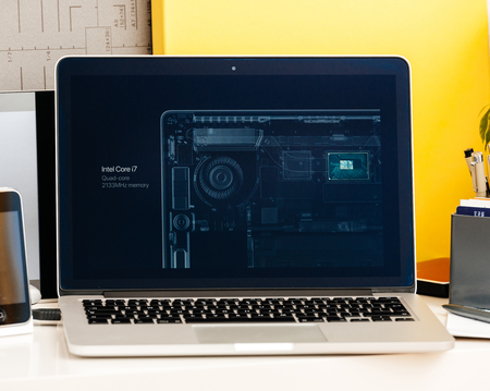 PARIS, FRANCE - OCT 28 2016: Apple Computers website on new MacBook Pro Retina with OLED Touch bar in geek creative room showcasing Apple Keynote presentation of Intel Core i& CPI and ramのeditorial素材