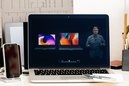 PARIS, FRANCE - OCT 28 2016: Apple Computers website on new MacBook Pro Retina with OLED Touch bar in geek creative room showcasing Apple Keynote - Philip Schiller comparing new MacBook Pro Retinaのeditorial素材