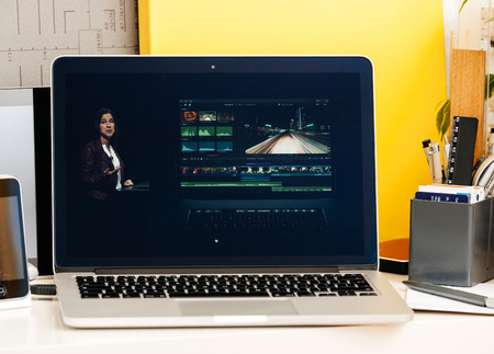PARIS, FRANCE - OCT 28 2016: Apple Computers website on new MacBook Pro Retina with OLED Touch bar in geek creative room showcasing Apple Keynote presentation of OLE and Final Cut Pro softwareのeditorial素材