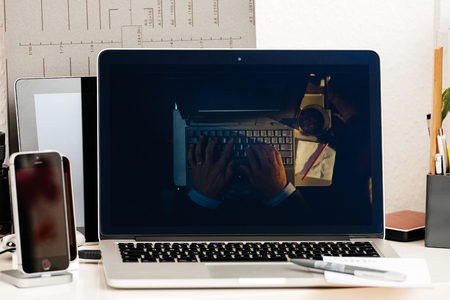 PARIS, FRANCE - OCT 28 2016: Apple Computers website on new MacBook Pro Retina with OLED Touch bar in geek creative room showcasing Apple Keynote presentation of evolution of typewriting machines and laptopsのeditorial素材