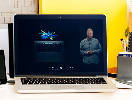 PARIS, FRANCE - OCT 28 2016: Apple Computers website on new MacBook Pro Retina with OLED Touch bar in geek creative room showcasing Apple Keynote - Philip Schiller presenting Touch Oled Barのeditorial素材