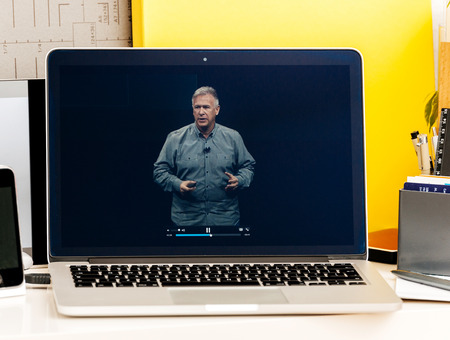 PARIS, FRANCE - OCT 28 2016: Apple Computers website on new MacBook Pro Retina with OLED Touch bar in geek creative room showcasing Apple Keynote - Philip Schiller speakingのeditorial素材