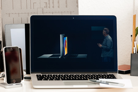 PARIS, FRANCE - OCT 28 2016: Apple Computers website on new MacBook Pro Retina with OLED Touch bar in geek creative room showcasing Apple Keynote Comparing, Shipping, Price, Specs of laptopsのeditorial素材