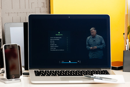 PARIS, FRANCE - OCT 28 2016: Apple Computers website on new MacBook Pro Retina with OLED Touch bar in geek creative room showcasing Apple Keynote presentation of Ecologial impact of new MacBook Proのeditorial素材