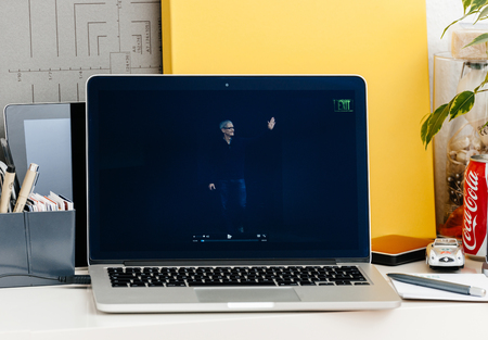 PARIS, FRANCE - OCT 28 2016: Apple Computers website on new MacBook Pro Retina with OLED Touch bar in geek creative room showcasing Apple Keynote presentation of Tim Cook saluting audienceのeditorial素材