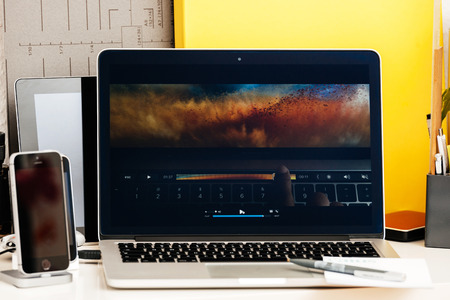 PARIS, FRANCE - OCT 28 2016: Apple Computers website on new MacBook Pro Retina with OLED Touch bar in geek creative room showcasing Apple Keynote presentation of image editing on macbook pro display oledのeditorial素材