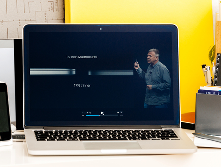 PARIS, FRANCE - OCT 28 2016: Apple Computers website on new MacBook Pro Retina with OLED Touch bar in geek creative room showcasing Apple Keynote presentation of  Philip Schiller talking about the changes of the new laptopのeditorial素材