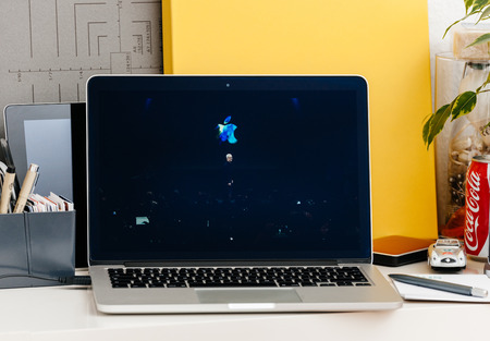 PARIS, FRANCE - OCT 28 2016: Apple Computers website on new MacBook Pro Retina with OLED Touch bar in geek creative room showcasing Apple Keynote presentation of Tim Cook saluting audienceのeditorial素材