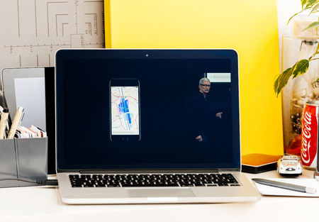 PARIS, FRANCE - OCT 28 2016: Apple Computers website on new MacBook Pro Retina with OLED Touch bar in geek creative room showcasing Apple Keynote presentation of detailed maps of transportationin Japanのeditorial素材