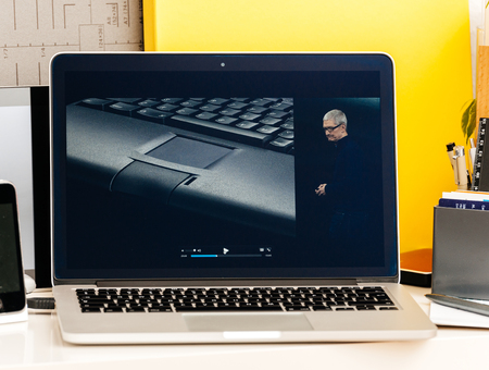 PARIS, FRANCE - OCT 28 2016: Apple Computers website on new MacBook Pro Retina with OLED Touch bar in geek creative room showcasing Apple Keynote - history of Macitosh PowerBook laptop and Tim Cookのeditorial素材