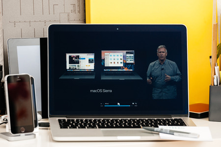 PARIS, FRANCE - OCT 28 2016: Apple Computers website on new MacBook Pro Retina with OLED Touch bar in geek creative room showcasing Apple Keynote presentation of Philip Schiller Presentation of the new specsのeditorial素材