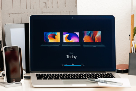 PARIS, FRANCE - OCT 28 2016: Apple Computers website on new MacBook Pro Retina with OLED Touch bar in geek creative room showcasing Apple Keynote Comparing, Shipping, Price, Specs of laptopsのeditorial素材
