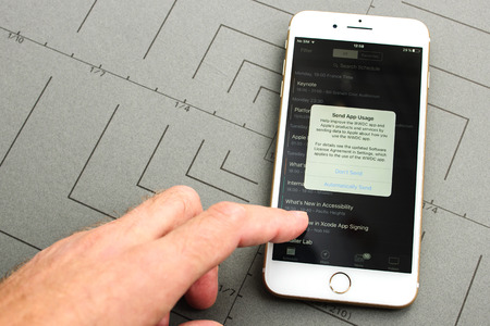 PARIS, FRANCE - SEPT 26, 2016: New iPhone 7 Plus with hand touching screen to permit app usage sent to Apple. iPhone 7 and iPhone 7 plus is the most wanted phone worldwideのeditorial素材