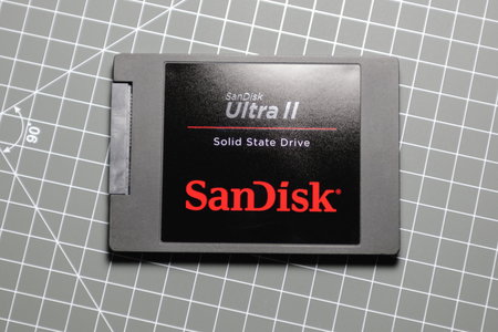 PARIS, FRANCE - DECEMBER 4, 2015: Modern Ultra fast SanDisk Ultra II SSD Solid State drive on table. SanDisk is an American manufacturer of flash memory products, including memory cards and readers, USB flash drives, and solid state drives.のeditorial素材