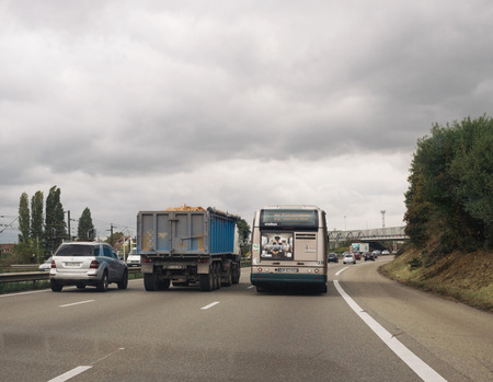 STRASBOURG, FRANCE - OCT 20, 2016: Public bus with Uber Advertising on it driving on busy French highway - driver point of viewのeditorial素材
