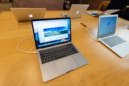 PARIS, FRANCE - NOV 10 2016: New latest MacBook Pro Retina with on wooden table. The fourth generation MacBook Pro was revealed on October 27, 2016. Phil Schiller described it as the "Thinnest and lightest MacBook Pro ever"のeditorial素材