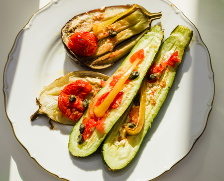 Organic eggplant aubergine coocked in owen with mix of tomato, capers, onions and cheeseの写真素材