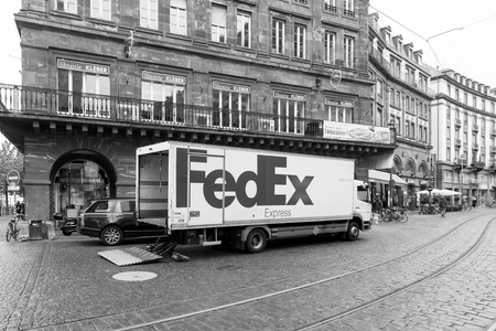 STRASBOURG, FRANCE - 8 NOV 2016: New FEDEX white truck unloading merchandise in beautiful city environment. FedEx is one of the leading parcel services worldwide with main competitors as DHL and UPSのeditorial素材