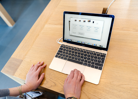 PARIS, FRANCE - SEP 12, 2016: Woman testing new Apple MacBook Pro Retina Laptop before buying it. MacBook Pro is ne of the most wanted laptop worldwideのeditorial素材