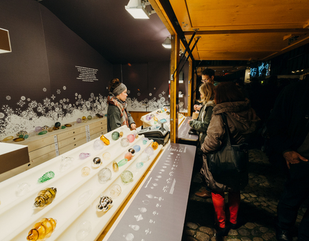 STRASBOURG, FRANCE - DEC 6, 2015: Adults, childrens, grandparents and happy people walking during Christmas Market admiring market stall, buying traditional Christmas Tree toysのeditorial素材