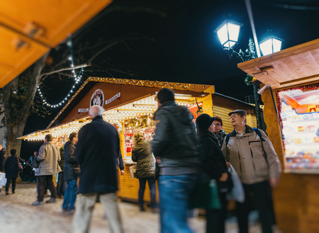STRASBOURG, FRANCE - DEC 6, 2015: Adults, childrens, grandparents and happy people walking during Christmas Market admiring market stall, buying food, presents and toysのeditorial素材